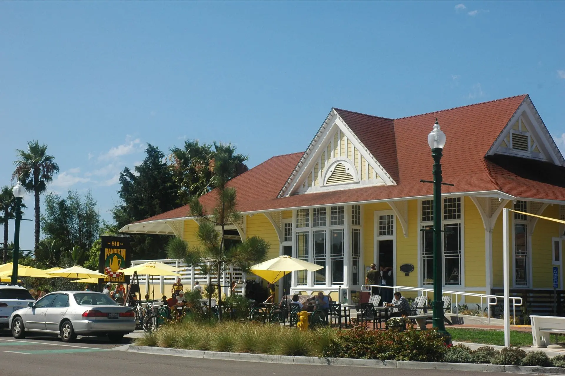 Yellow building with outdoor dining area.